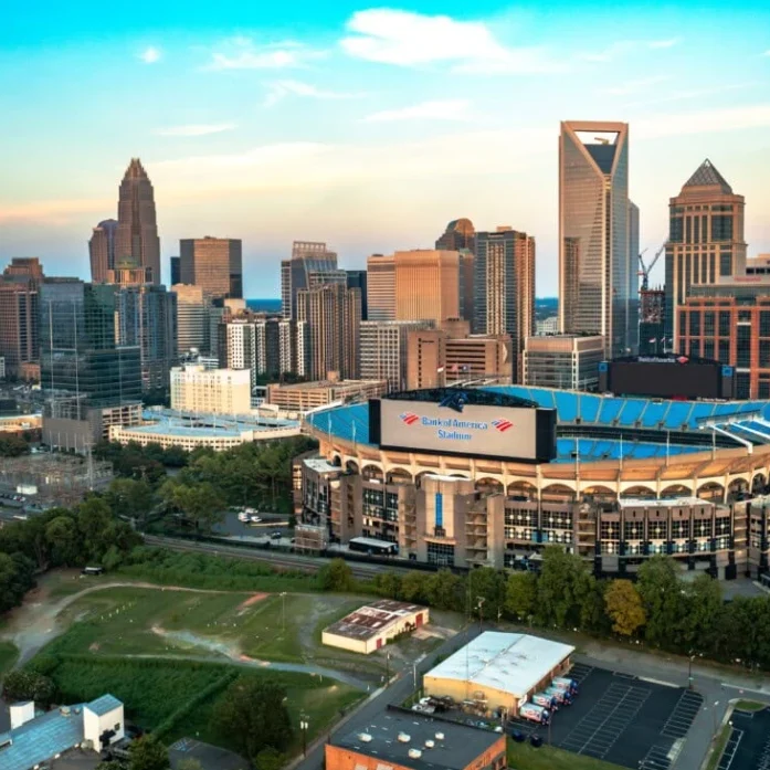 A team of Google Ads professionals reviewing data on a monitor in an office with a view of the Charlotte.